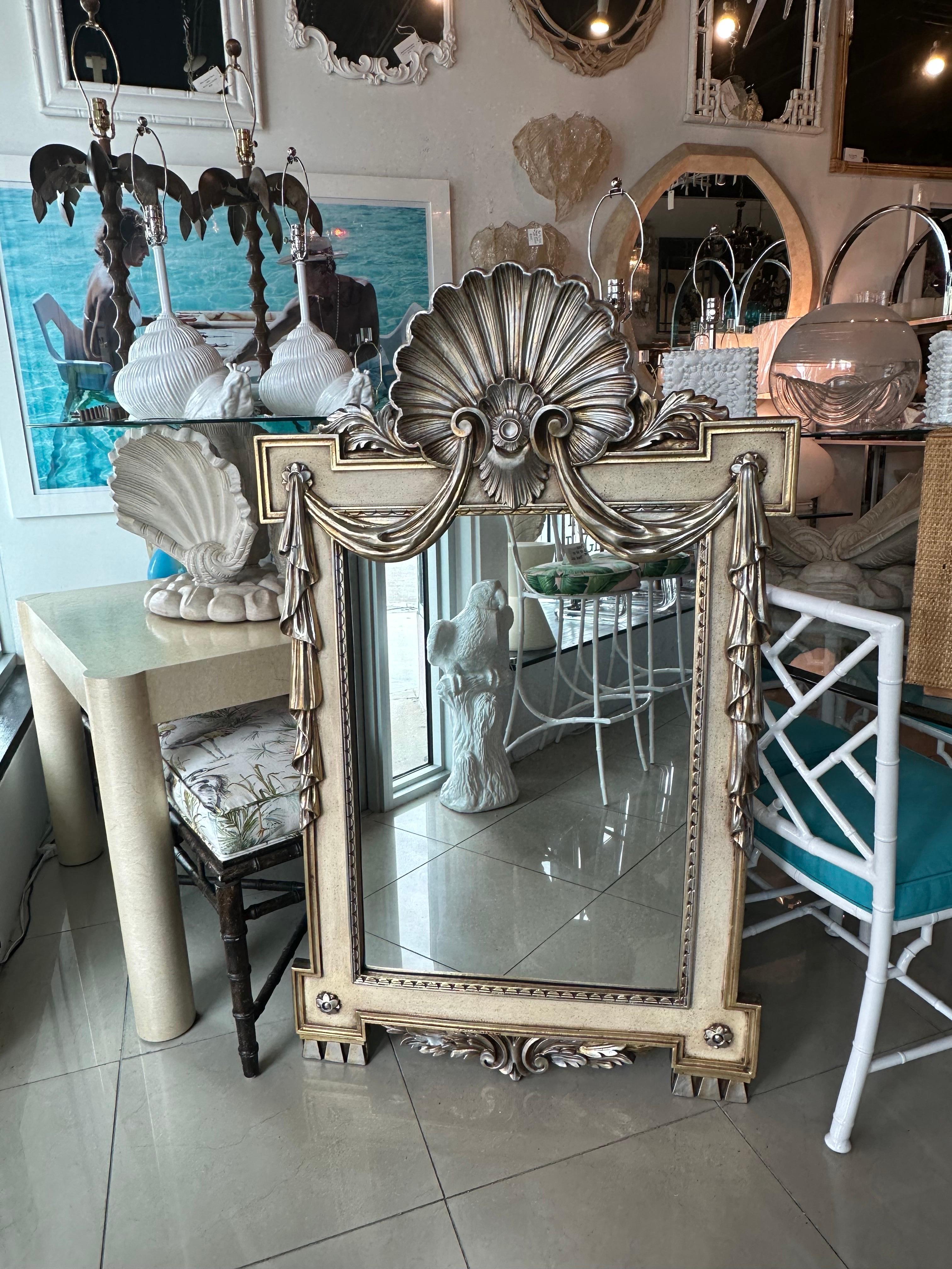 Vintage silver and gold draped shell wall mirror. Original silver & gold finish. Comes ready to hang. Dimensions: 55.5 H x 33.25 W x 2.5 D.