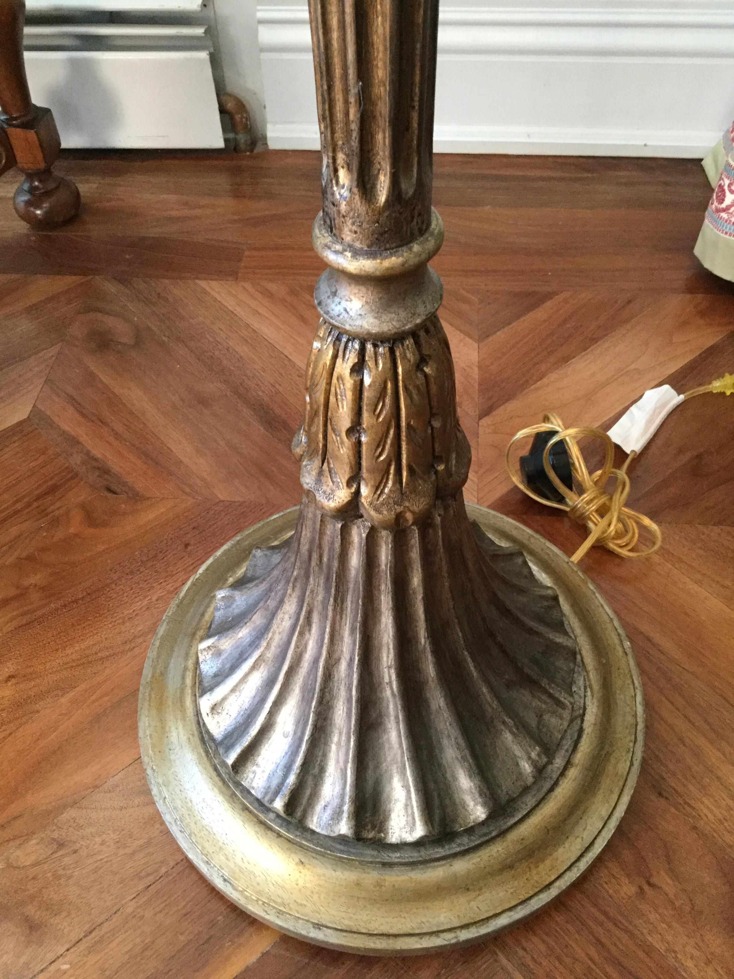 Made of wood, this elegant 4-arm floor lamp features shirred beige lampshades. The central lamp post has gold and silver overtones. The base is round and features acanthus leaves. The arms are made of metal and nicely chased. Mint condition.