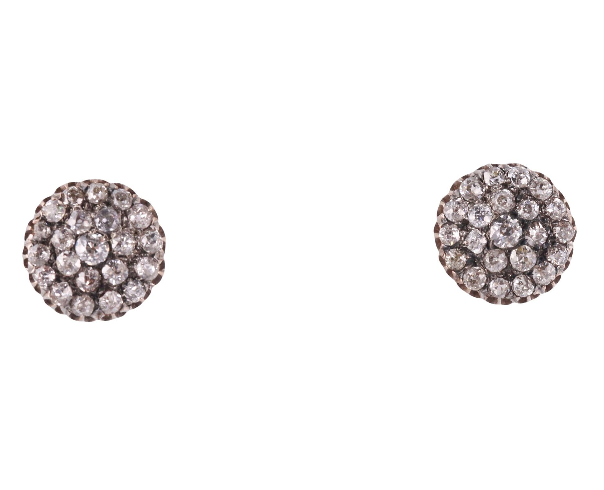 Pair of 14k gold and silver stud earrings, set with a total of approx.  2.30ctw in old mine cut diamonds. The earrings measure 14mm in diameter and weigh 3.7 grams. Not marked, tested 14k and silver. With screw posts.