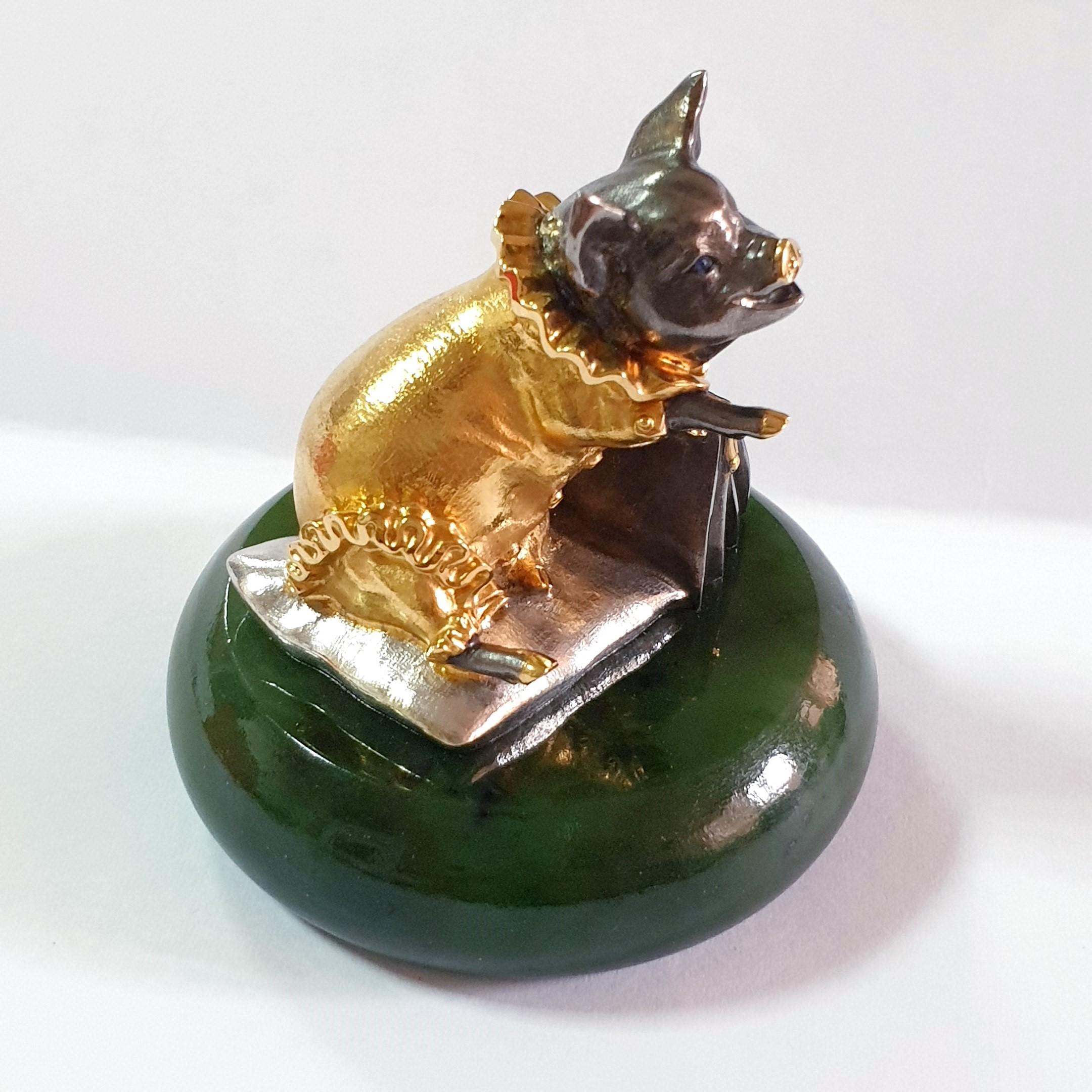 A pig, a symbol of fertility and abundance, was made into a silver miniature with a creative idea and masterful craftsmanship. A genuine silver with gold plated pig has lively facial features with sapphire eyes. A nicely dressed pig sitting on a