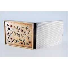 Silver-gold toiletry box with floral cut lid and five red cabochons