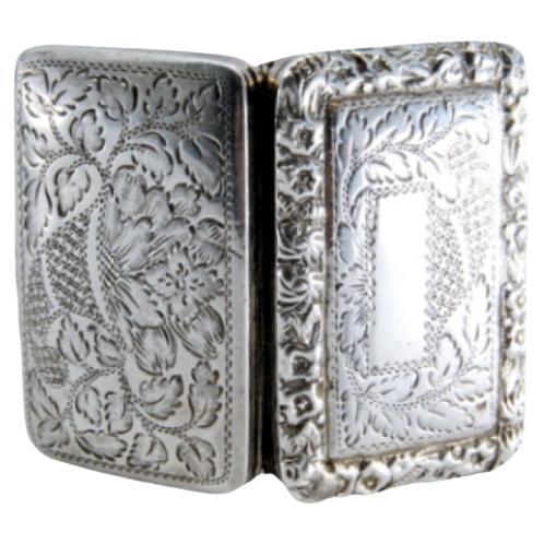 Silver-gold vinaigrette box with book-shaped engraved lid, George IV period
