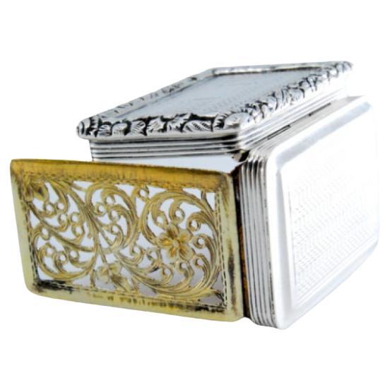 Silver-gold vinaigrette box with friezes and relief lid, George IV period