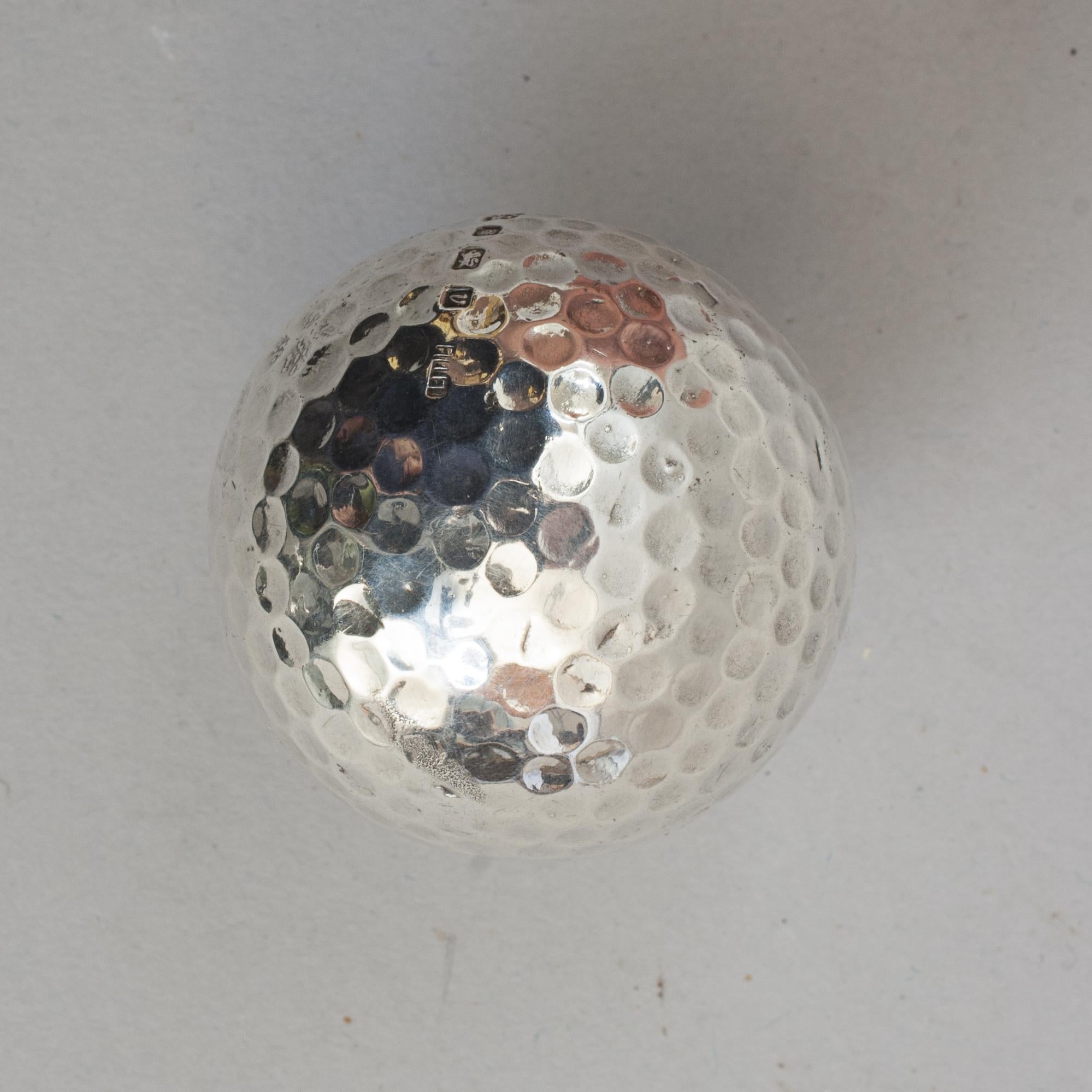 Hallmarked Silver Golf Ball.
An unusual silver golf ball, made by Chantry Silversmiths with a filled center and hallmarked Sheffield 1995. The dimple patterned silver golf ball stamped 'CS' (Chantry Silversmiths) with Sheffield Rose Assay Office