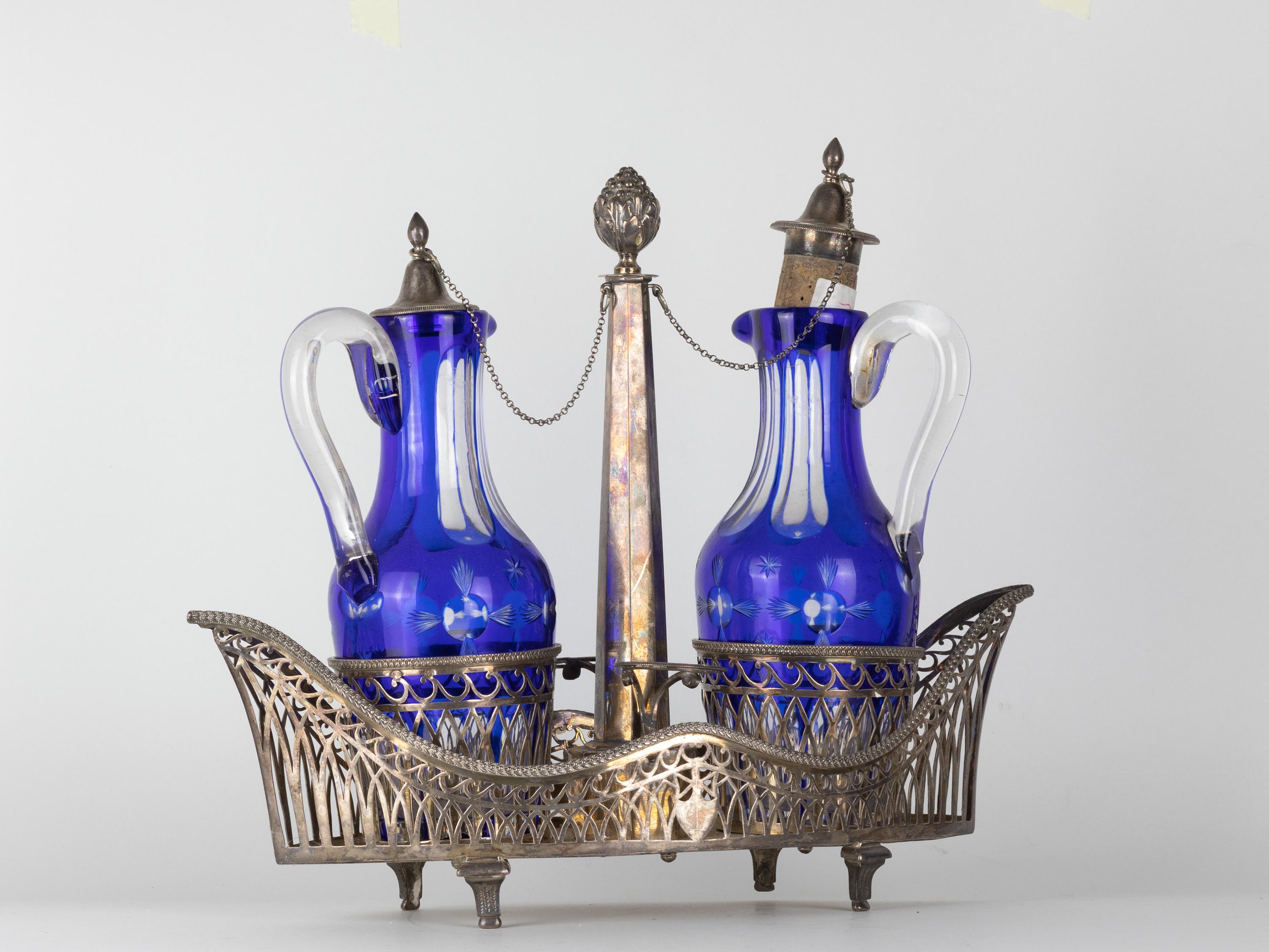 A Silver Cruet table Lombardo Veneto (Venice) set in finely pierced silver, decorated with caryatids form and fret patterns.  Set consisting of oil cruet, salt, pepper, Venice gondola shaped. Engraved silver marks. Grams 1290. 19th Century - circa