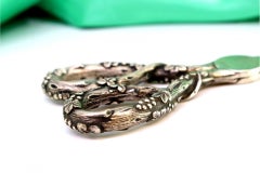 Silver grape scissors with reliefs of bunches and vines on the handle
