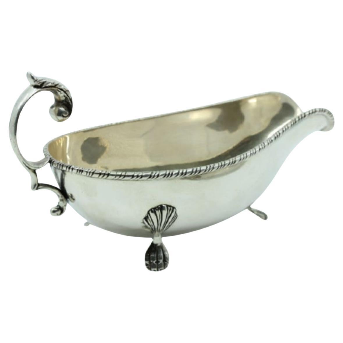 Silver gravy boat and platter with lost handles and edge friezes