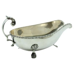 Silver gravy boat and platter with lost handles and edge friezes