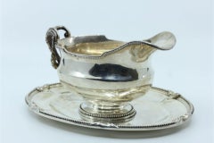 Silver gravy boat and platter with pearly surround and appliqués on the plate