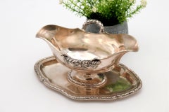 Silver gravy boat with plate, beaded handles, and ambidextrous system