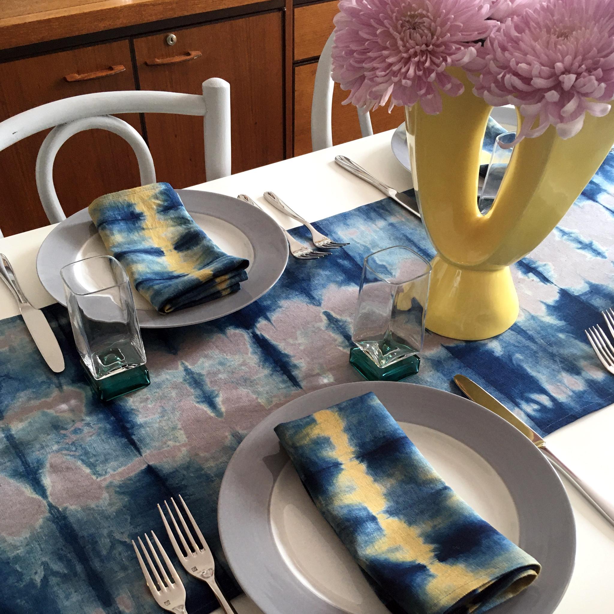 Silver gray linen table runner dyed with indigo in Pleat pattern. Hand-dyed and sewn in New York City. Runner measures approximately 18 x 72 inches. Each linen runner is hand dyed and one of a kind. 

Each linen panel is cut and folded by hand, in