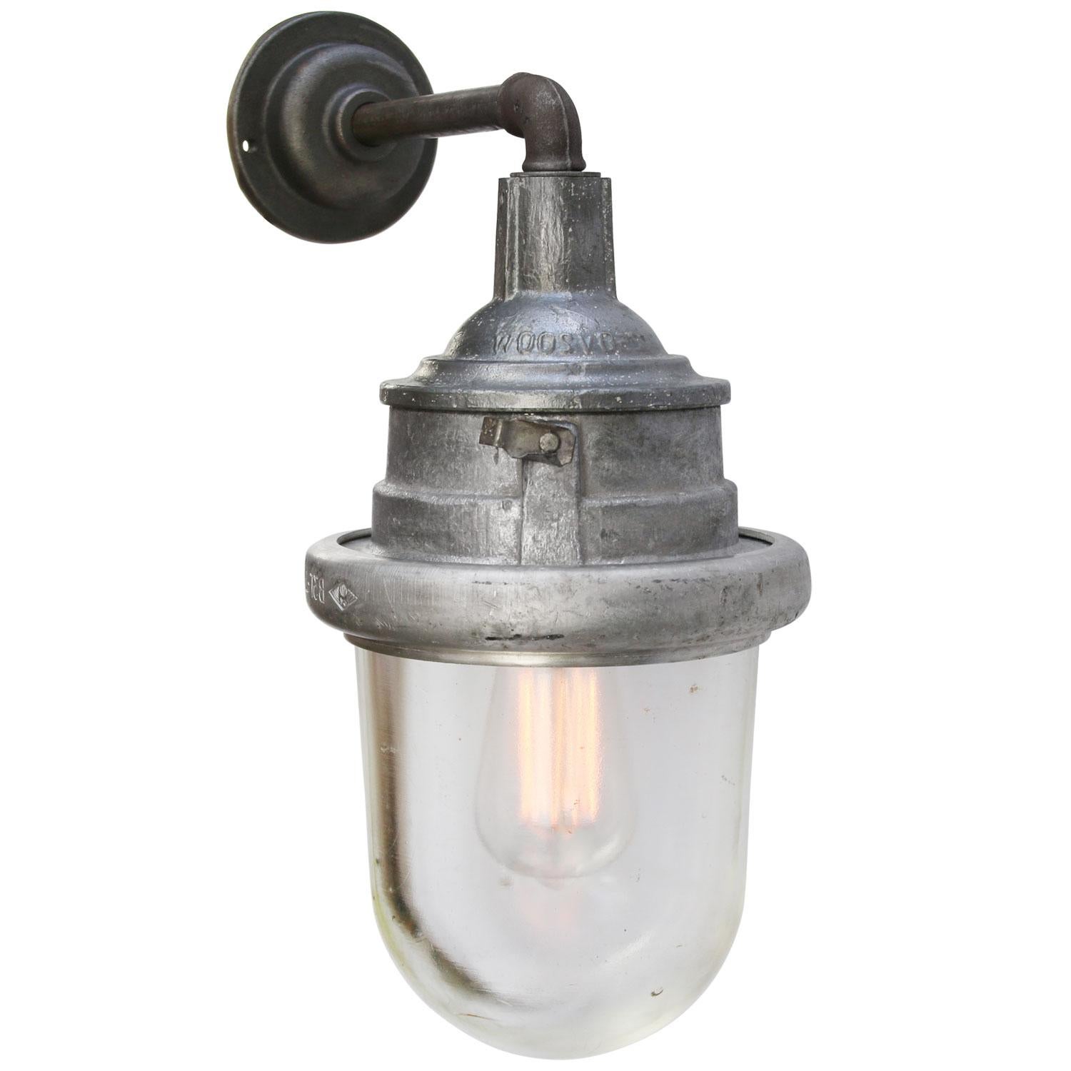 Cast iron and aluminium industrial wall light
clear glass

diameter cast iron wall piece 10 cm, 2 holes to secure

Weight: 5.50 kg / 12.1 lb

Priced per individual item. All lamps have been made suitable by international standards for