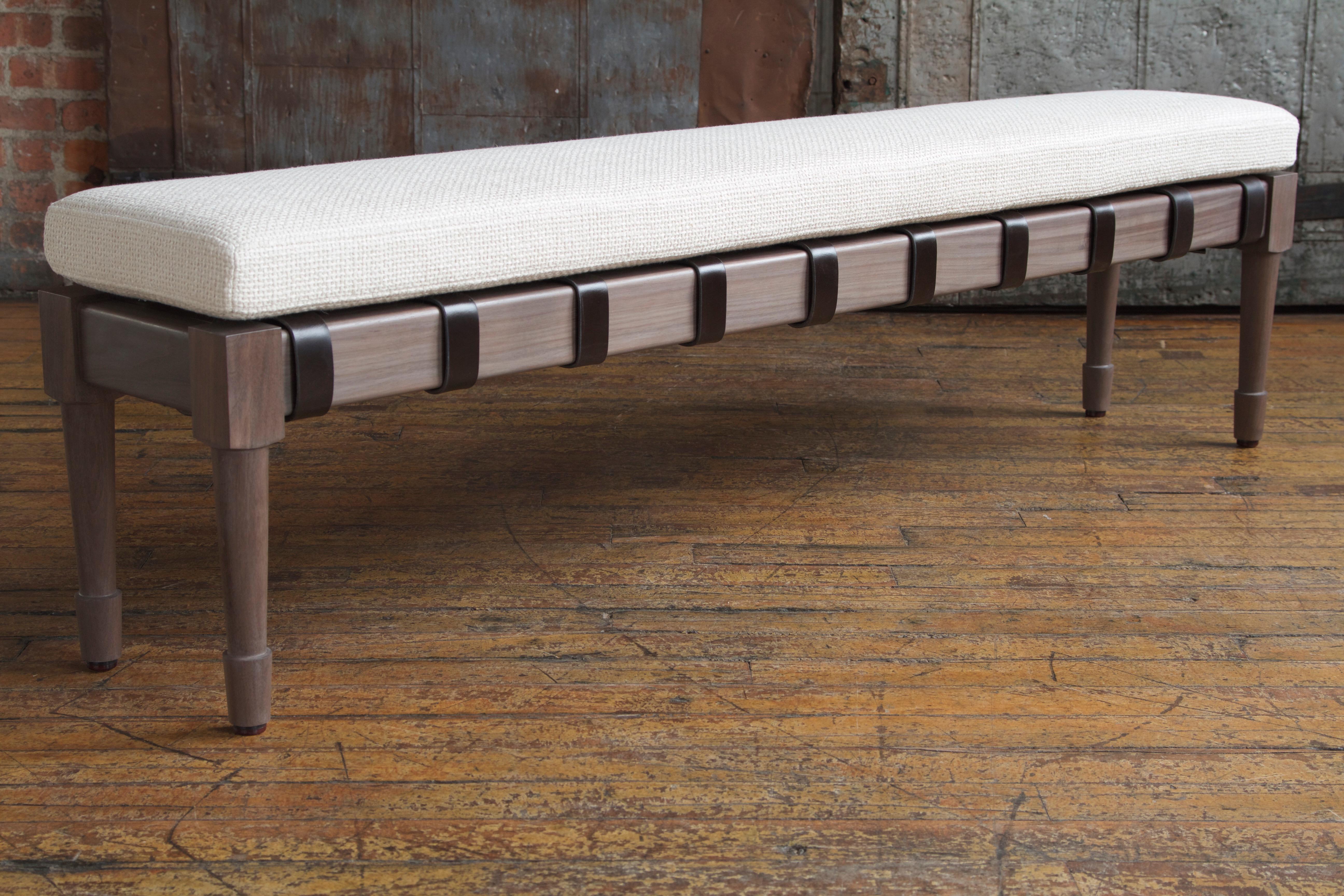 The Jasper bench in silver grey walnut with Perennials: Tisket Tasket / Sea Salt upholstery and dark chocolate English bridle strapping leather.

The modern campaign collection by Richard Wrightman combines the vernacular of traditional form with a