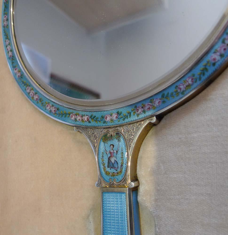 Antique silver, guilloche and hand painted enamel and watercolor on ivory hand mirror. A quite extraordinary tour de force and one of the finest hand mirrors that I have ever seen. The mirror itself in excellent condition and perfectly clear and
