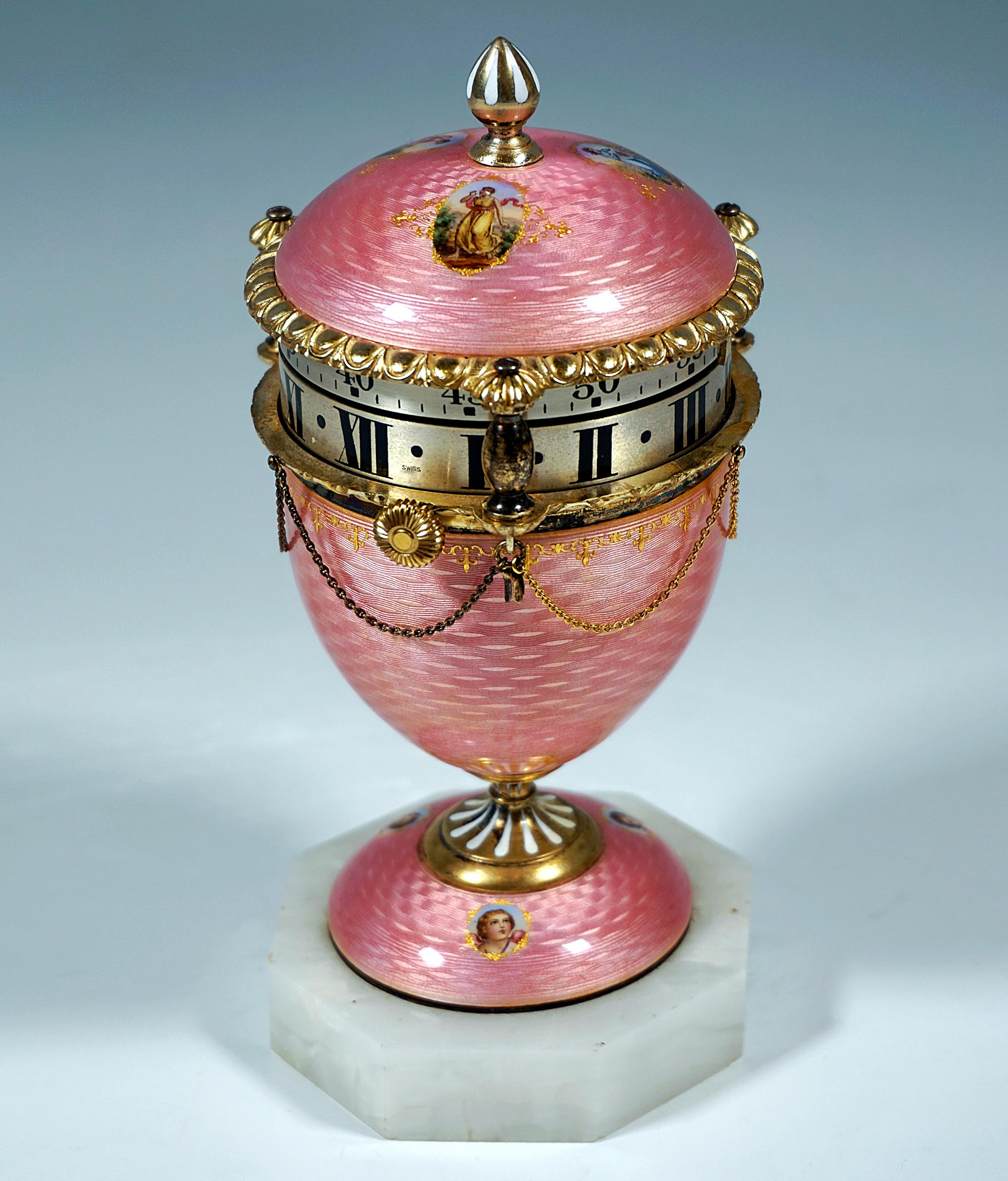 Fancy Cercle Tournant Timepece:
Silver urn-shaped case with stepped base, covered with pink guilloche enamel, seven oval medallions with polychrome enamel painting with bucolic depictions and putti heads, all silver mountings and connectors with