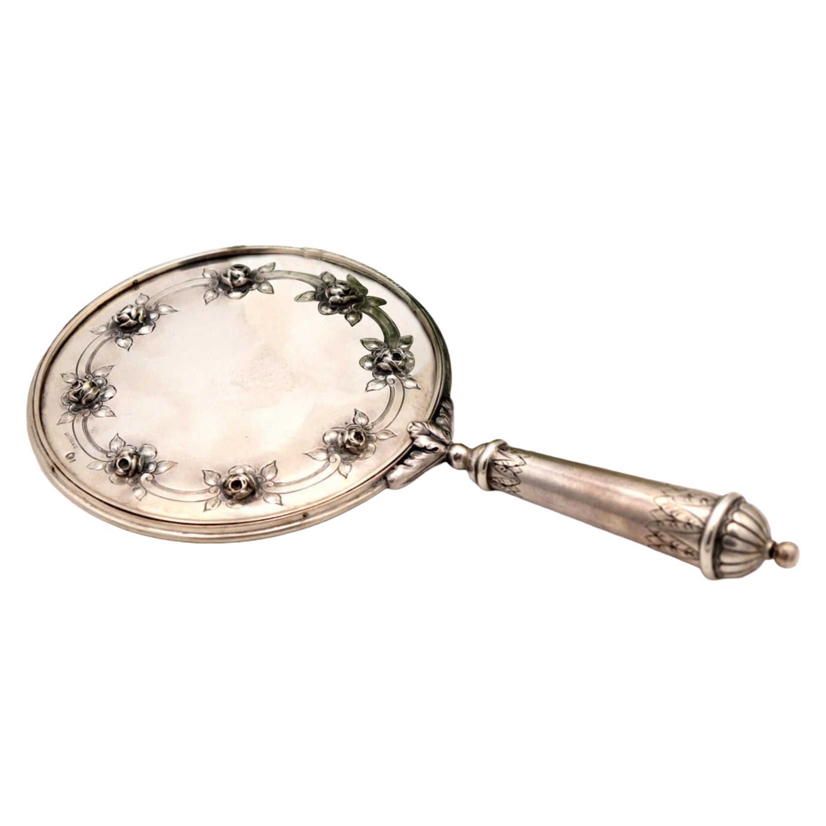 Silver hand mirror with reliefs and rose applications on the back