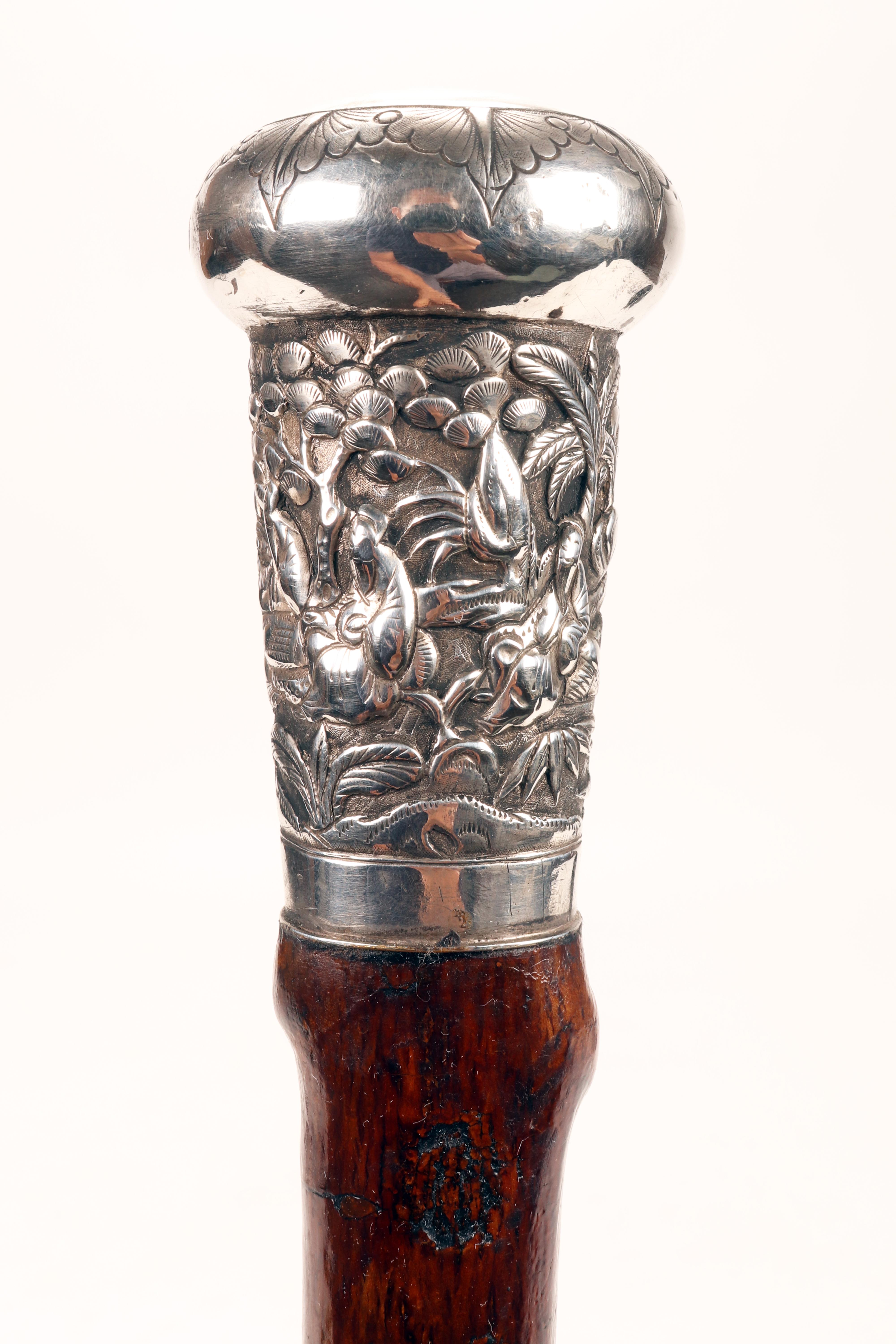 Walking stick with rustic cane in fruit wood and embellished handle. Tip and barrel, in a single solution show the shoots of the cut plant in progression along the development. The barrel is waxed. The handle, in silver, is a milord at the top of