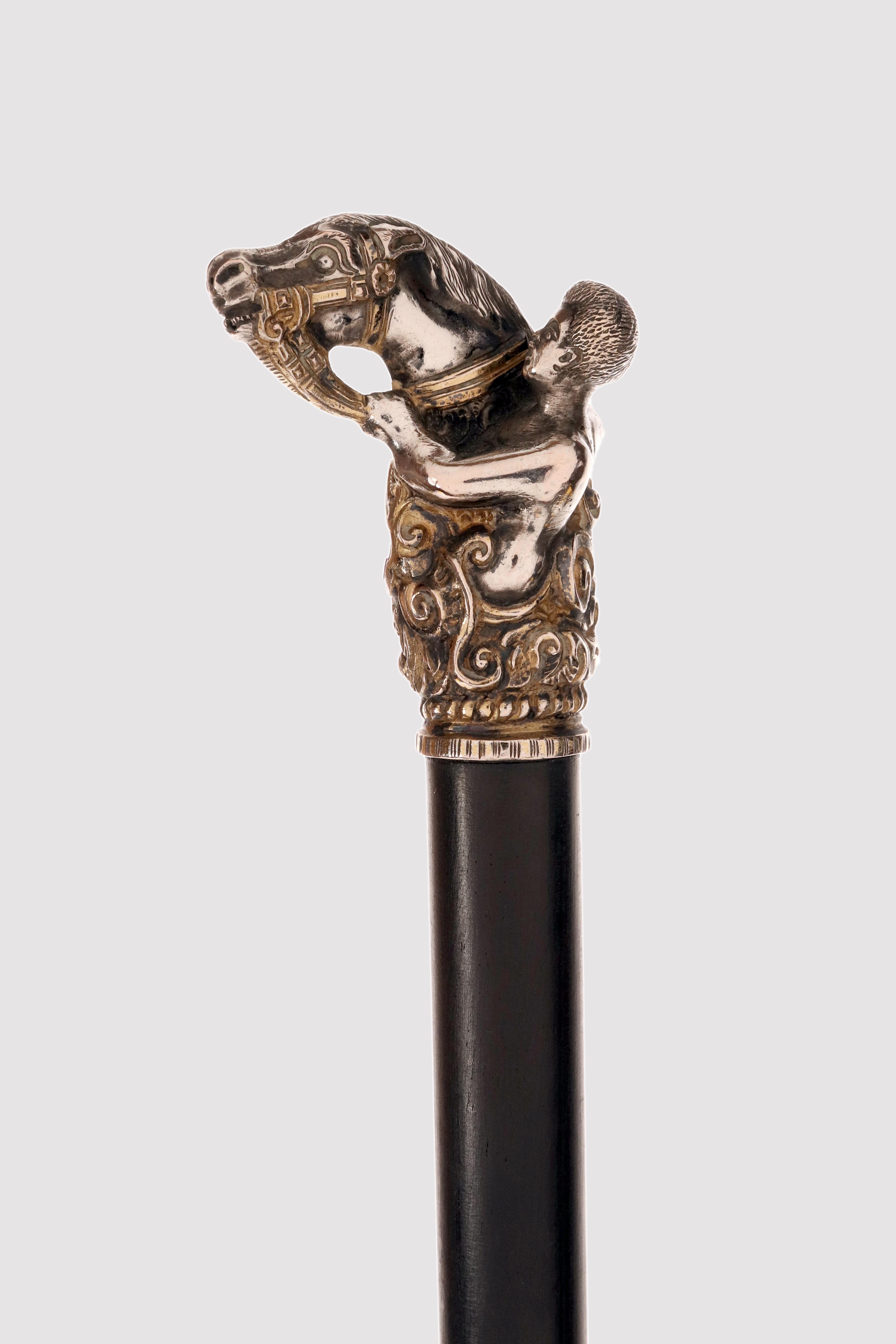 Walking stick: golden silver handle depicting a horse head and a jockey. Ebony wood shaft, metal ferrule. United Kingdom early 1900s. 