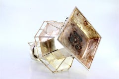 Silver headlight with raised applications and a hammered square base