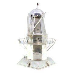 Silver headlight with raised applications and a hammered square base