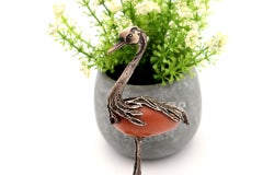 Silver heron with reliefs on hard stone perched on water lily leaf