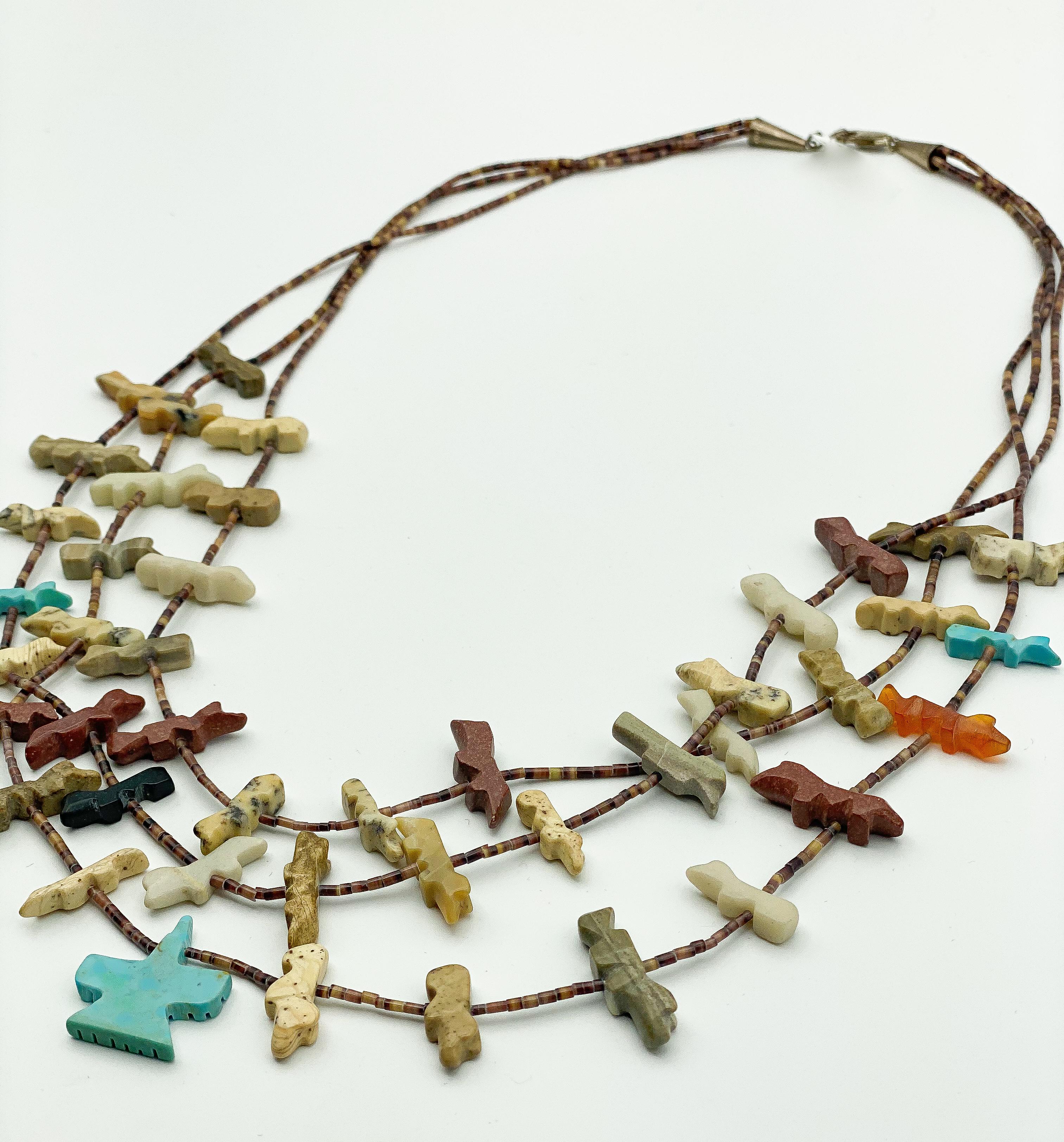 Hand carved stone; 

Silver Heshi, Turquoise, Agate; 

Small beads; Multi Strand necklace 

Approximately 28 inches in length 