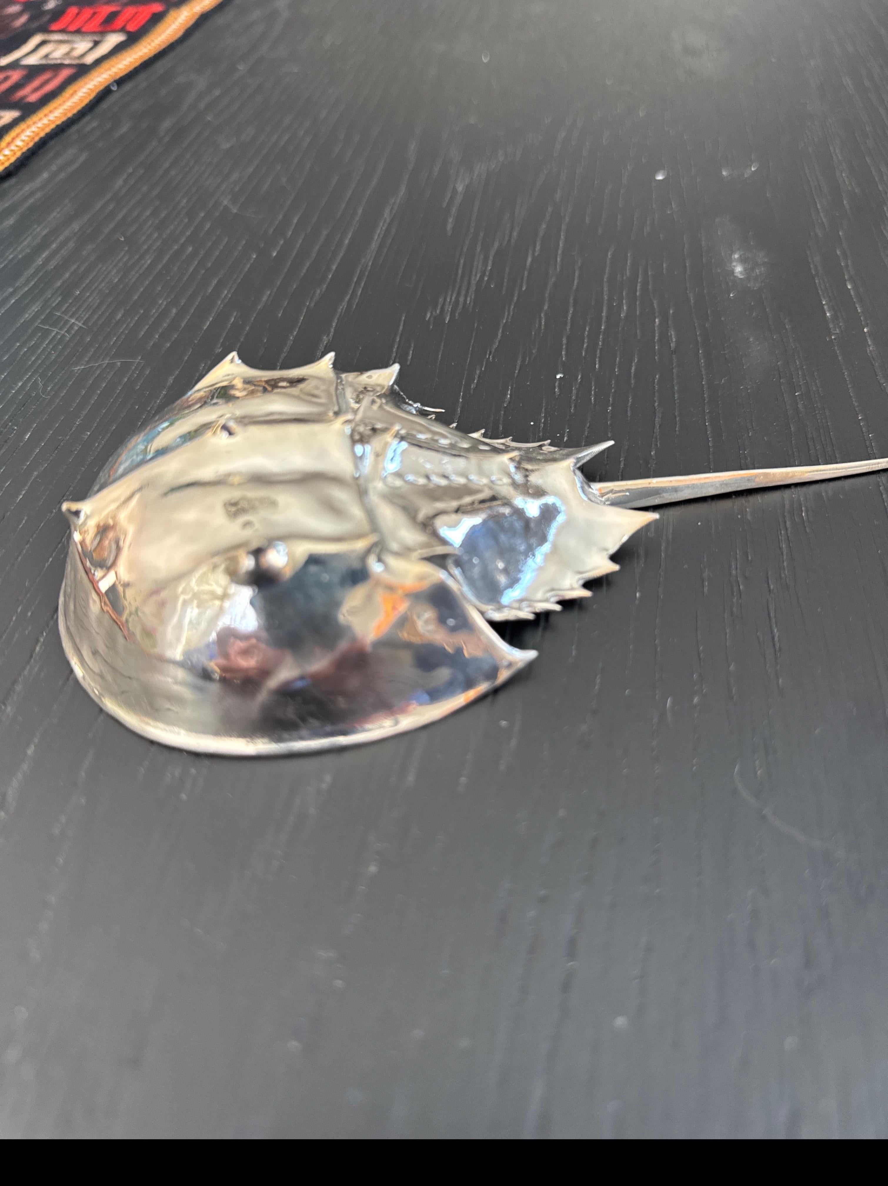 This is a stunning silver horseshoe crab that was cast from a horseshoe crab. I found in Maine. It will add elegance and Grace to any desk or shelf or could be the perfect bookmark. It is entirely unique and extraordinary.

This horseshoe crab will