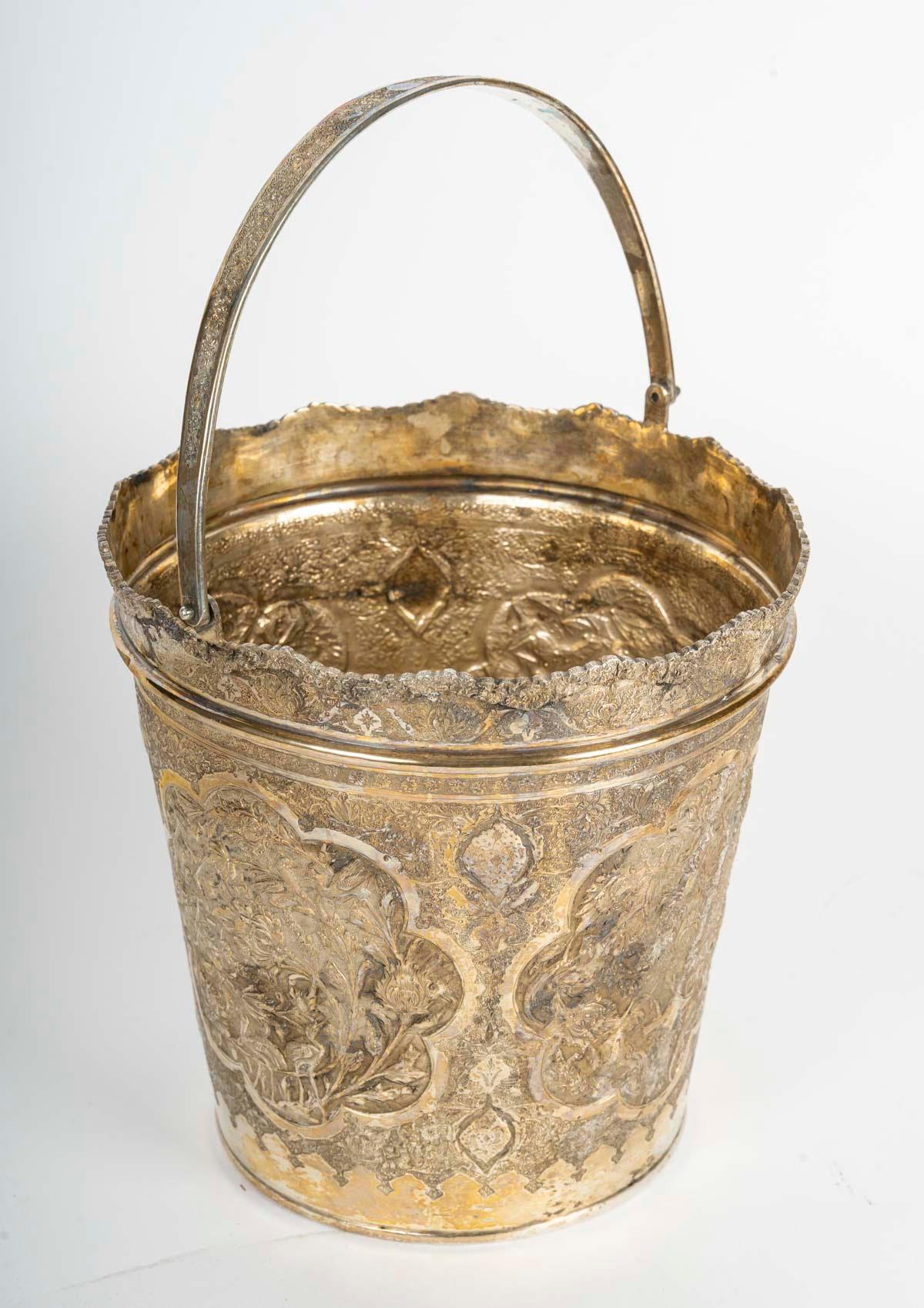 Silver ice bucket, 19th century Orientalist work.

A 19th century Orientalist silver ice bucket, probably Iranian.
H: 19,5cm, D: 20cm