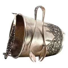 Silver ice bucket w/ embossed florals, handle 
claw tongs