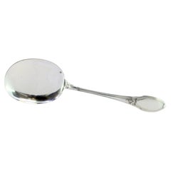Silver ice cream scoop with smooth shell and crimped reliefs along the handle