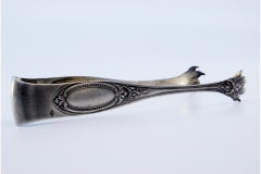 Silver ice tongs in claw shape with monogram card
