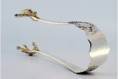 Silver ice tongs in the shape of bird claws
