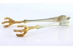 Silver ice tongs in the shape of bird claws