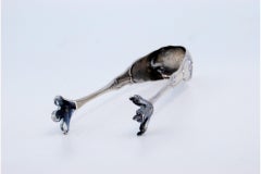 Silver ice tongs in the shape of claws
