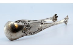 Silver ice tongs in the shape of claws