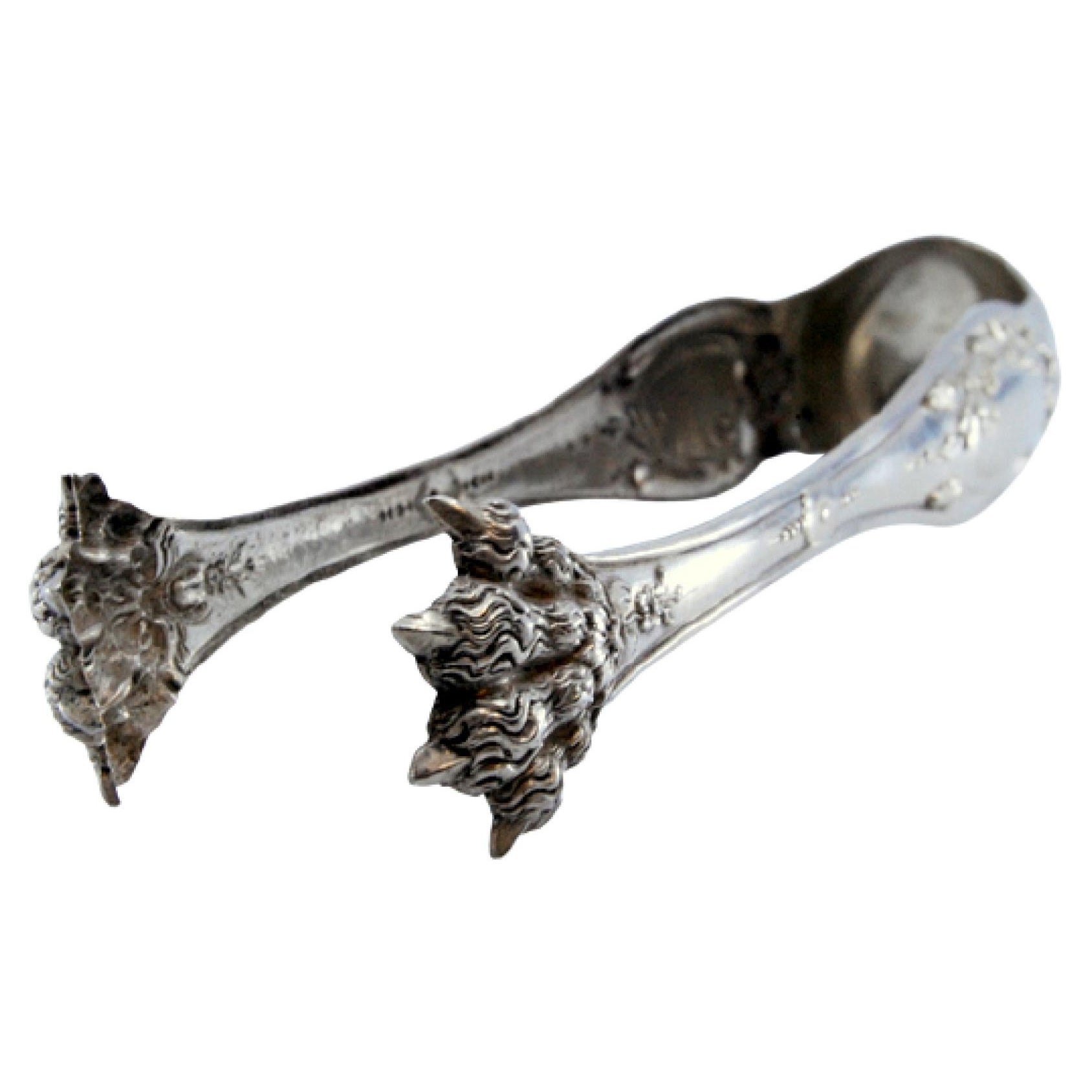 Silver ice tongs in the shape of claws