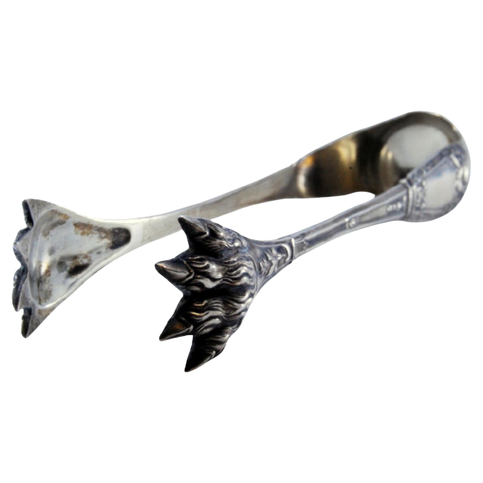 Silver ice tongs in the shape of claws
