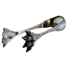 Silver ice tongs in the shape of claws