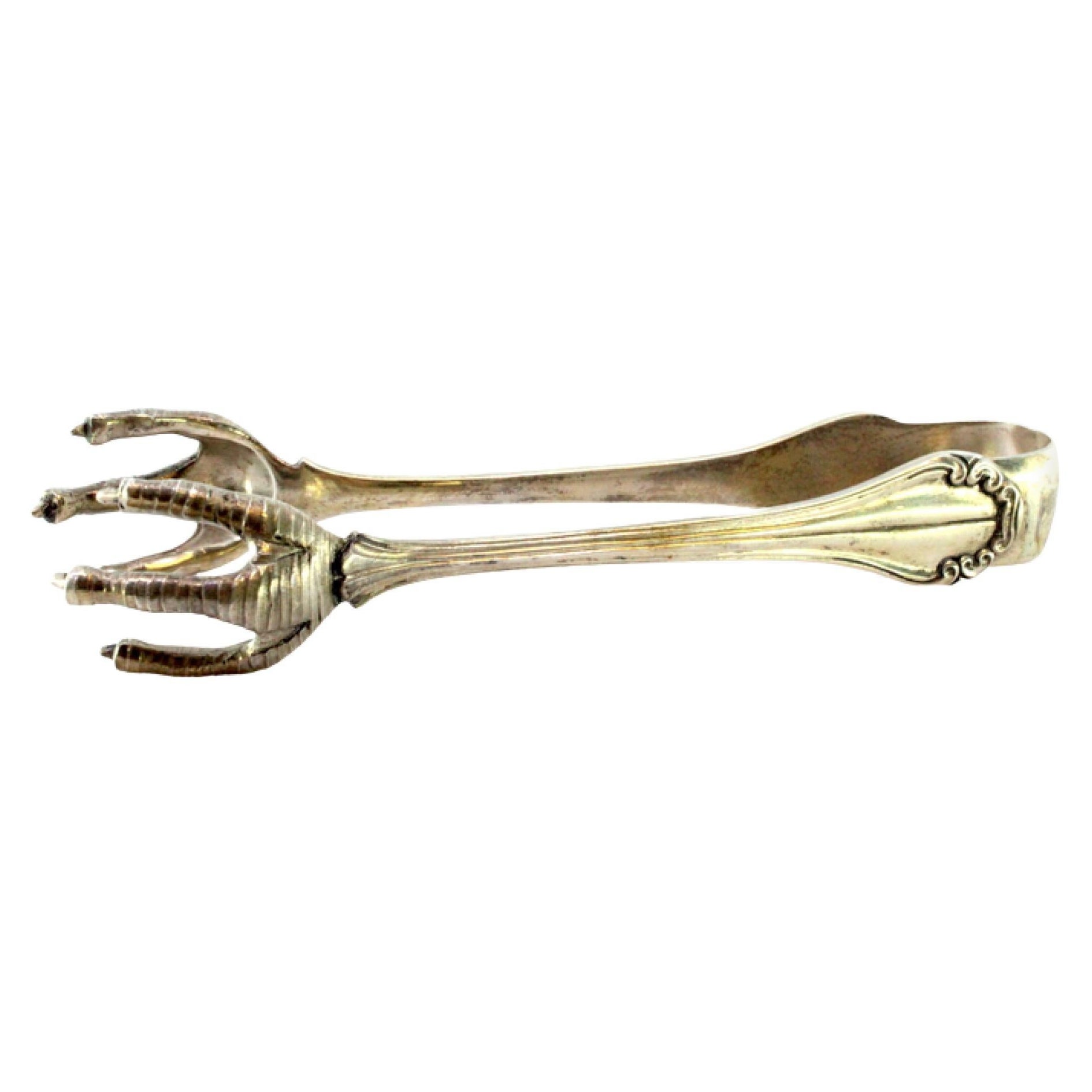 Silver ice tongs in the shape of revealed claws