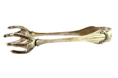 Silver ice tongs in the shape of revealed claws