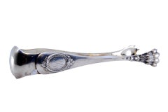 Silver ice tongs with claws and medallions on both sides