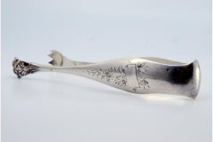 Silver ice tongs with floral reliefs and claw-shaped tongs
