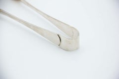 Silver ice tongs with reliefs