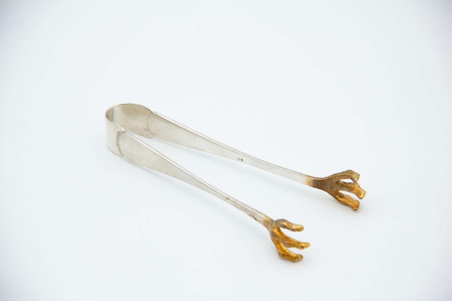 Silver ice tongs with reliefs