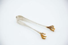 Silver ice tongs with reliefs