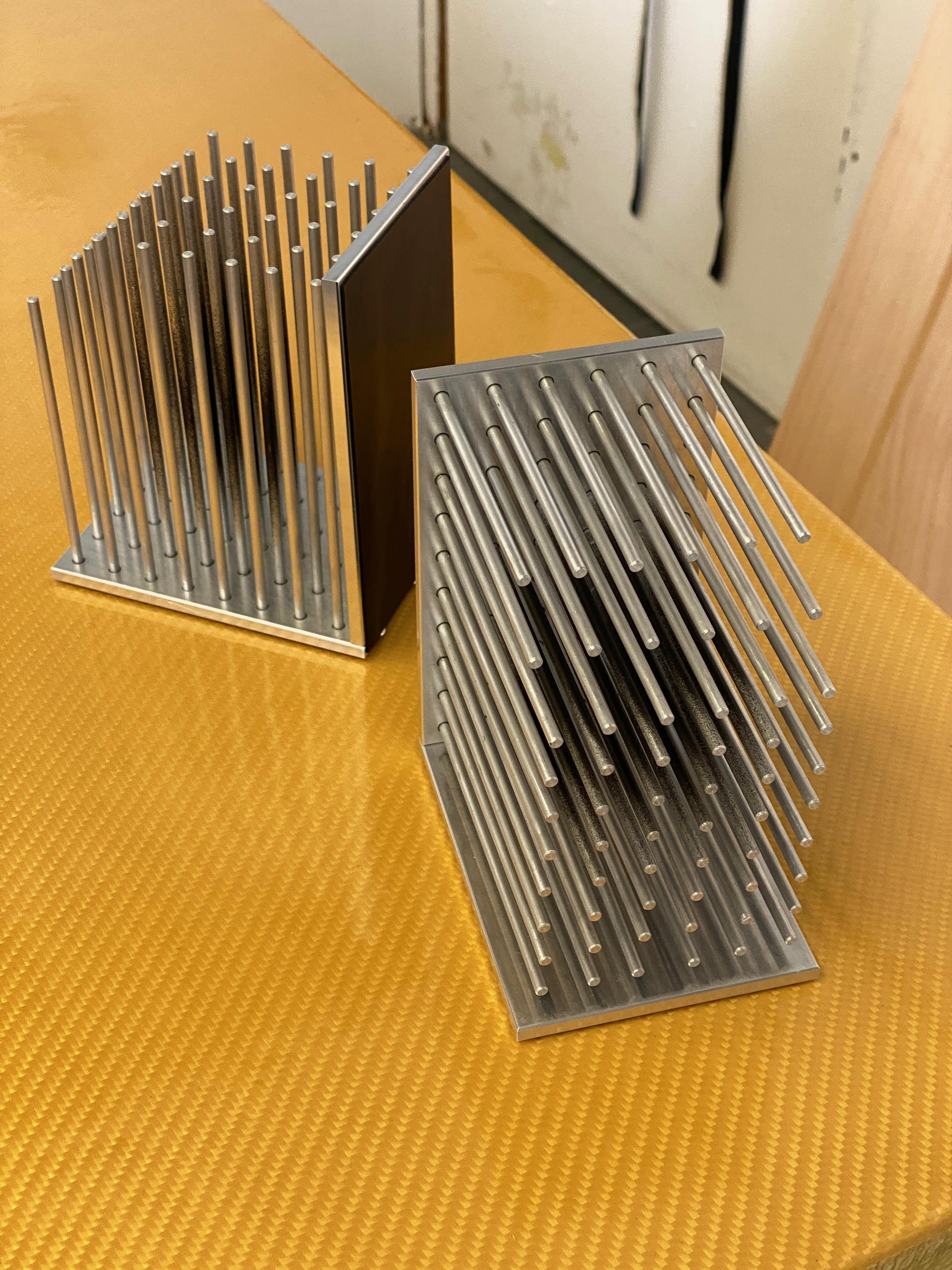 The bookends are a continuation of Tino Seubert's RCA graduation project The Colour of Air and were commissioned for Ma-tt-er's book launch at London Design Festival 2018. They are inspired by the aesthetics of air filters. Made from milled raw