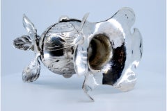 Silver inkwell in the shape of a knight's helmet with a shell at the base