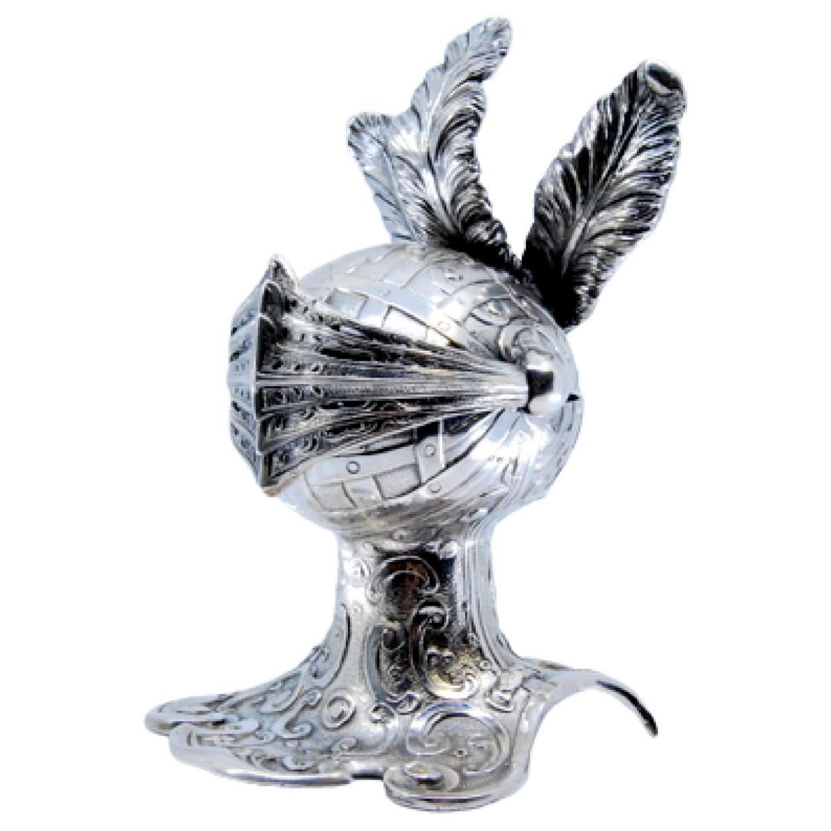 Silver inkwell in the shape of a knight
s helmet with a shell at the base