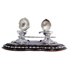 Silver inkwell on rosewood with helmet-shaped tanks 
pen holder
