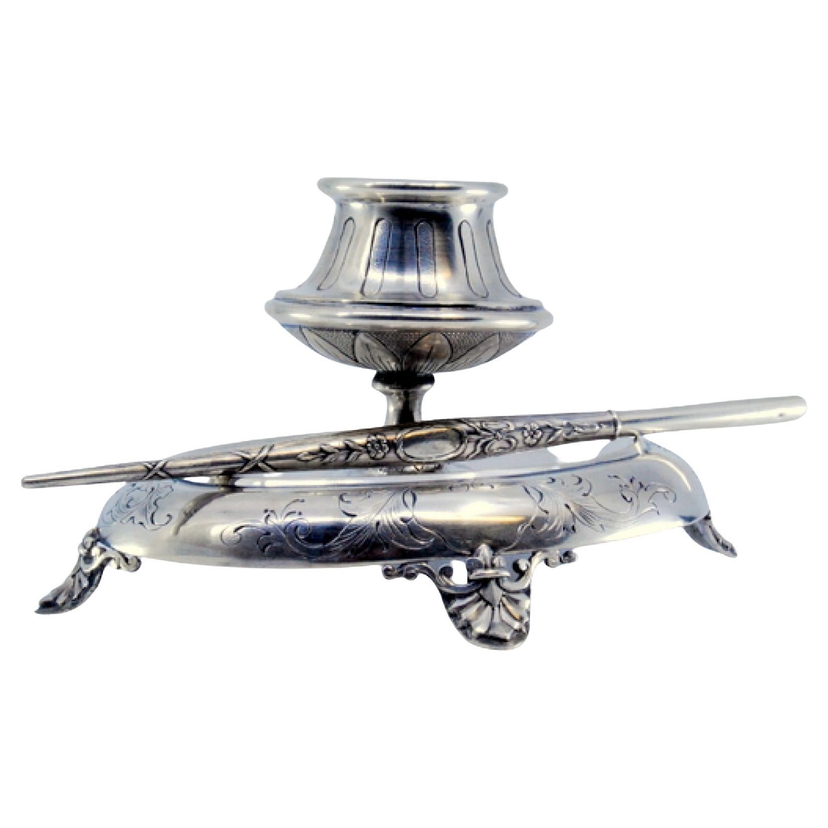 Silver inkwell with chiseled base, four support feet and pen